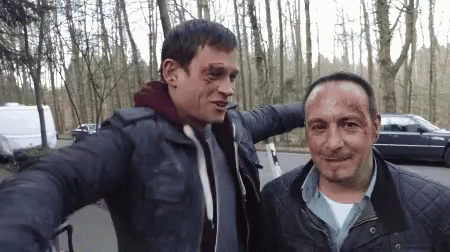 Two Men Are Posing For A Picture And One Has A Bruise On His Head GIF