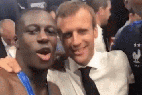 Two Men Are Posing For A Picture Together And One Of Them Is Wearing A Shirt That Says France . GIF