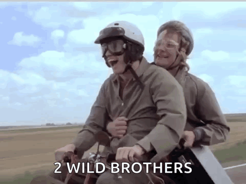 two men are riding a motorcycle with a saw on their backs .