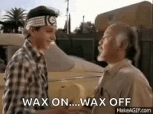 Two Men Are Shaking Hands In Front Of A Car And Talking . GIF