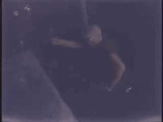 Two Men Are Singing Into Microphones On A Stage . GIF