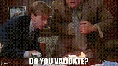 Two Men Are Sitting At A Table And One Of Them Is Asking The Other If He 'S Validated GIF