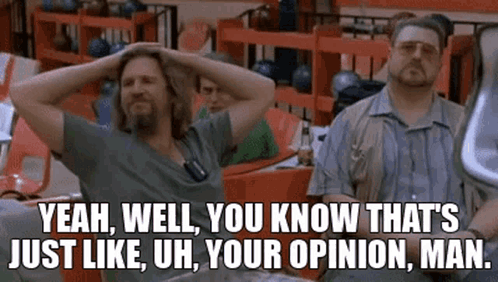 Two Men Are Sitting At A Table In A Bowling Alley With Their Hands On Their Head . GIF