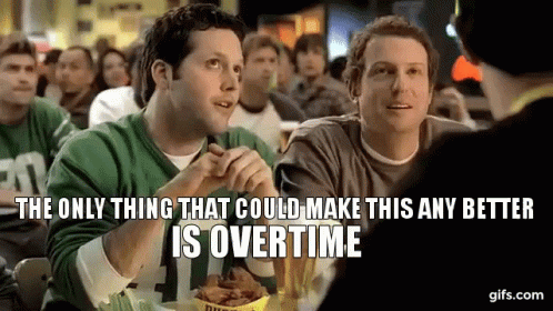 Two Men Are Sitting At A Table In A Restaurant Eating Chicken Wings . GIF