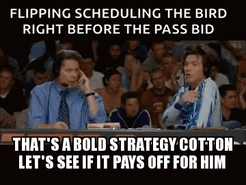 Two Men Are Sitting At A Table In Front Of A Crowd Talking On A Cell Phone . GIF