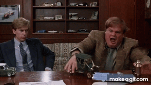 Two Men Are Sitting At A Table With Makeagif.com Written On The Bottom Right GIF