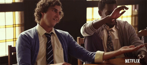 Two Men Are Sitting At A Table With The Word Netflix On The Bottom GIF