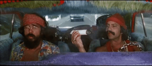 Two Men Are Sitting In A Car And One Is Holding A Cigarette GIF