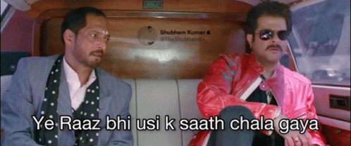 Two Men Are Sitting In A Car And One Of Them Is Wearing A Pink Jacket GIF