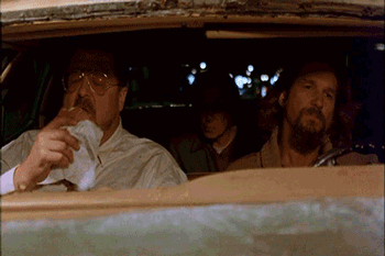 Two Men Are Sitting In A Car One Is Smoking A Cigarette GIF