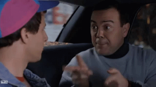 Two Men Are Sitting In A Car Talking To Each Other And One Of Them Is Wearing A Pink Hat . GIF
