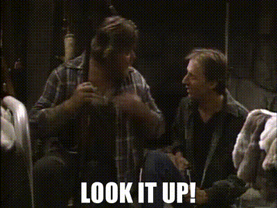 Two Men Are Sitting In A Dark Room With The Words Look It Up Written On The Bottom GIF
