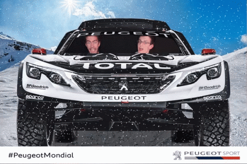 Two Men Are Sitting In Front Of A Peugeot Total Vehicle GIF