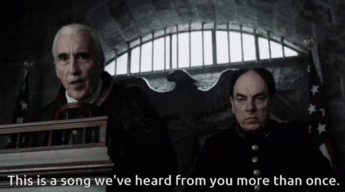 Two Men Are Sitting In Front Of A Podium With The Words " This Is A Song We 'Ve Heard From You More Than Once " GIF