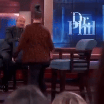 Two Men Are Sitting In Front Of A Screen That Says Dr Phil On It GIF