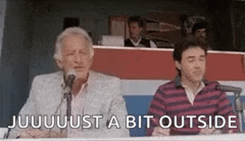 Two Men Are Sitting In Front Of Microphones And One Of Them Is Talking . GIF