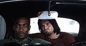Two Men Are Sitting In The Back Seat Of A Car And Looking At The Rear View Mirror . GIF
