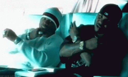Two Men Are Sitting Next To Each Other In A Car And One Is Wearing A Hat That Says Mlb On It GIF