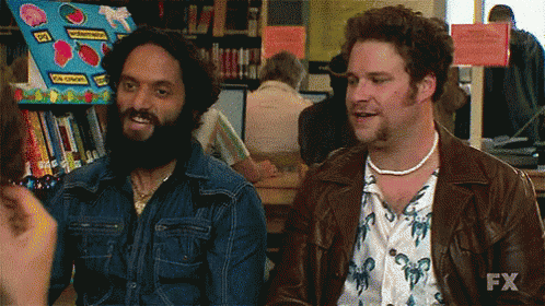 Two Men Are Sitting Next To Each Other In A Library And One Of Them Is Saying Nailed It GIF