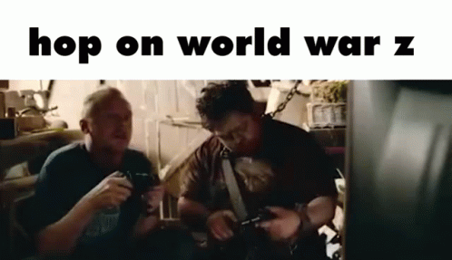 Two Men Are Sitting Next To Each Other In A Room Playing Video Games . GIF