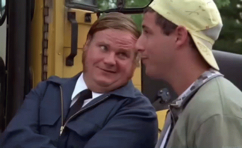 Two Men Are Sitting Next To Each Other In Front Of A Yellow Bus And Talking To Each Other . GIF