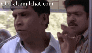 Two Men Are Sitting Next To Each Other On A Bus And One Of Them Is Pointing . GIF