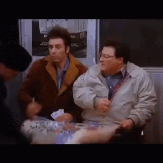 Two Men Are Sitting Next To Each Other On A Subway And Talking . GIF