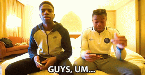 two men are sitting on a bed and one of them says " guys um ... "
