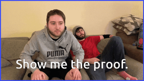 Two Men Are Sitting On A Couch And One Has A Puma Sweatshirt On GIF