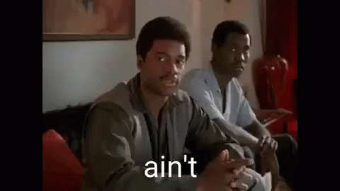 Two Men Are Sitting On A Couch And One Of Them Is Talking To The Other . GIF