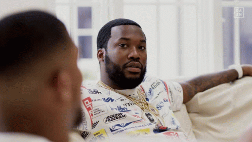 Two Men Are Sitting On A Couch And One Of Them Is Wearing A Shirt That Says " Freedom " GIF