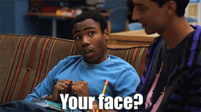 Two Men Are Sitting On A Couch And One Of Them Says Your Face GIF