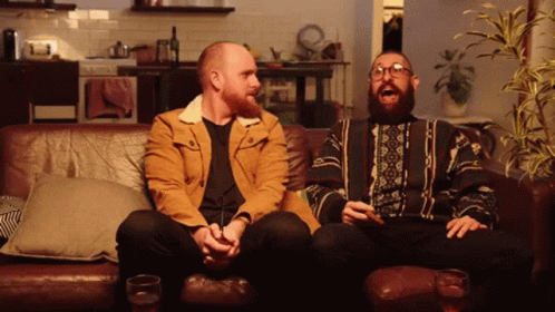 Two Men Sitting On Couch Laughing GIF