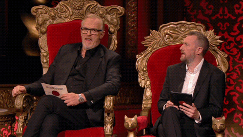 two men are sitting on a throne and one of them is holding a piece of paper that says ' the master ' on it