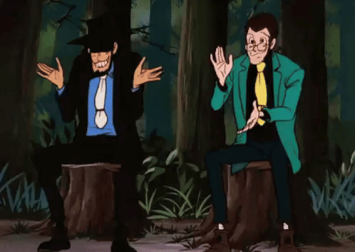 Two Men Are Sitting On A Tree Stump In A Forest . GIF