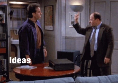 Two Men Are Standing Around A Table With The Words Ideas Written On The Bottom GIF