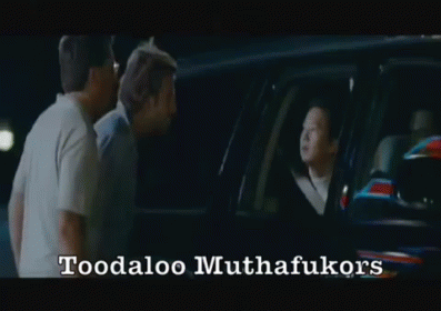 Two Men Are Standing In Front Of A Car With The Words Toodaloo Muthafukukors Written On The Bottom GIF