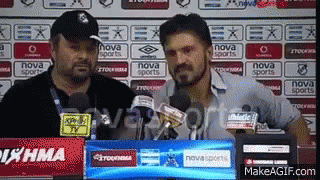 Two Men Are Standing In Front Of A Nova Sports Sign GIF