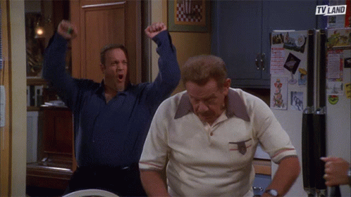 Two Men Are Standing In Front Of A Refrigerator That Says Tv Land On It GIF