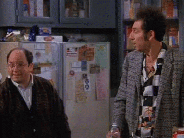 Two Men Are Standing In Front Of A Refrigerator With A Sticker On It That Says ' I Love You ' GIF