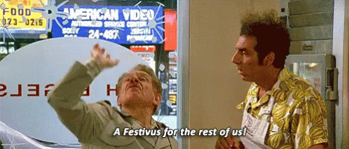 Two Men Are Standing In Front Of A Sign That Says American Video . GIF