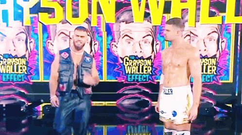 two men are standing in front of a wall that says grayson waller