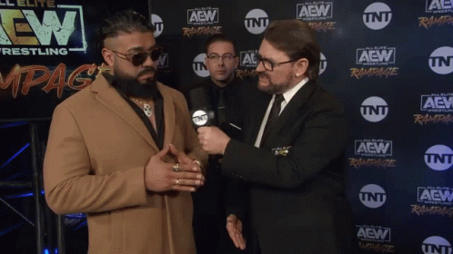Two Men Are Standing In Front Of A Wall With Aew Wrestling Written On It GIF