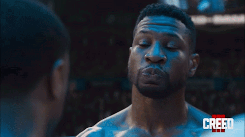 Two Men Are Standing Next To Each Other And Looking At Each Other In A Boxing Ring . GIF