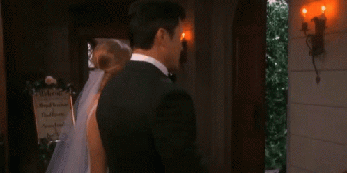 two men are standing next to each other and looking at each other in a room .