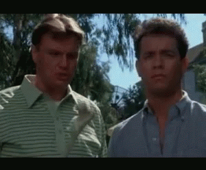Two Men Are Standing Next To Each Other And Looking At Each Other GIF