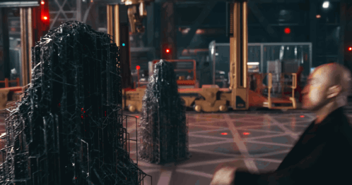 Two Men Are Standing Next To Each Other And One Has A Red Stripe On His Suit GIF