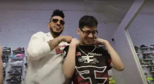 Two Men Are Standing Next To Each Other And One Has A Shirt That Says Nissan On It GIF