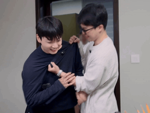 Two Men Are Standing Next To Each Other And One Has A Watch On GIF