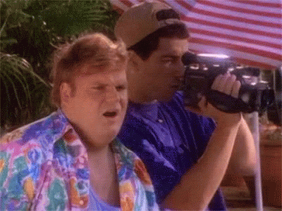 Two Men Are Standing Next To Each Other And One Is Holding A Camera . GIF